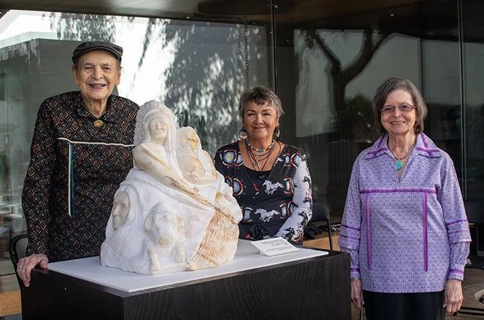 Artist Kathy Whitman Elk Woman (center) unveils the commissioned "Honor the Treaties" sculpture alongside Wayne Mitchell '60 (right) and his wife, Marie Mitchell,  at the Heard Museum in Phoenix, Arizona. (Photo by Heard Museum/Melissa Malork)  
